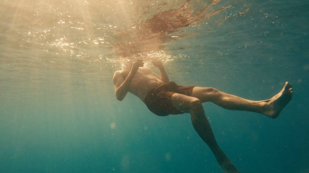 Cinematic frame from a luxury resort in Crete by The Film Tailors, showcasing poolside lifestyle and relaxed coastal experience