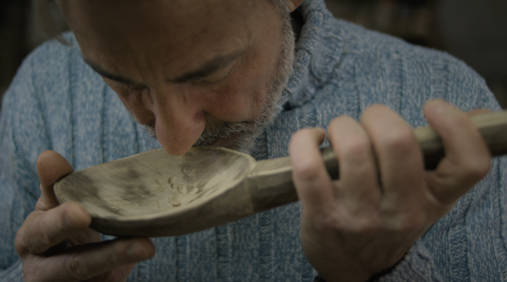 Cinematic frame from a travel film in Agios Nikolaos Crete by The Film Tailors, featuring a traveler experiencing the region across seasons