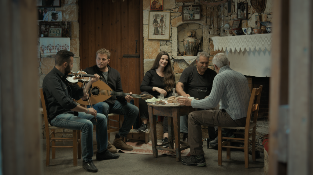 Cinematic frame from a travel film in Agios Nikolaos Crete by The Film Tailors, featuring a traveler experiencing the region across seasons